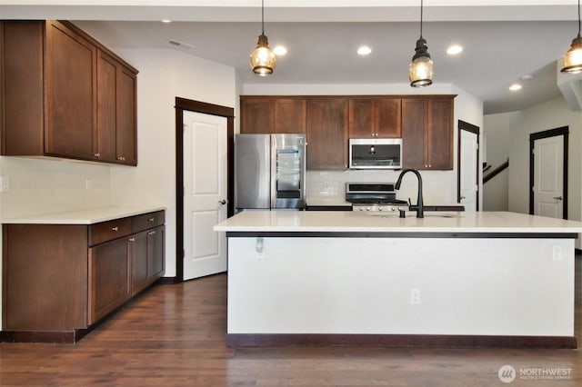 17723 3rd Ave SE, Bothell, WA 98012 - kitchen featuring appliances with stainless steel finishes, backsplash, light countertops, decorative light fixtures, and recessed lighting