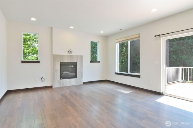 17723 3rd Ave SE, Bothell, WA 98012 - unfurnished living room with wood finished floors, a fireplace, and recessed lighting