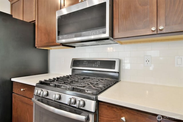 17723 3rd Ave SE, Bothell, WA 98012 - kitchen featuring stainless steel appliances, backsplash, and light countertops