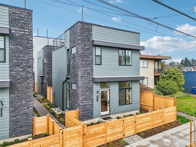 7741 15th Ave NE Unit C, Seattle, WA 98115 - modern home featuring a fenced front yard