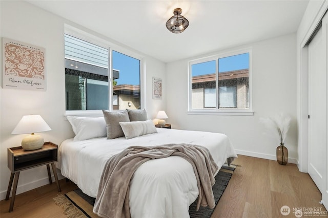 7741 15th Ave NE Unit C, Seattle, WA 98115 - bedroom with a closet, baseboards, and wood finished floors
