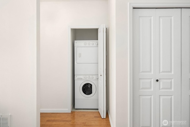 23420 SE Black Nugget Rd Unit E-302, Issaquah, WA 98029 - laundry room featuring estacked washer and dryer and light wood-style flooring