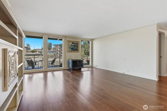 3717 Beach Dr SW Unit 113, Seattle, WA 98116 - unfurnished living room with healthy amount of natural light and dark wood-style floors