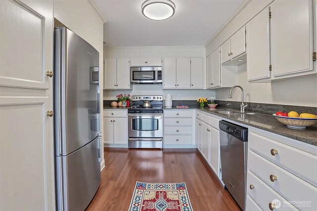 3717 Beach Dr SW Unit 113, Seattle, WA 98116 - kitchen with appliances with stainless steel finishes, white cabinetry, and dark wood-type flooring