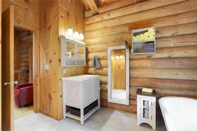 4004 Saje Ln, Sedro Woolley, WA 98284 - full bath featuring a freestanding tub, vanity, log walls, and tile patterned floors