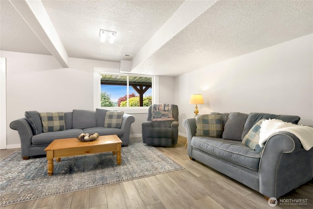 4004 Saje Ln, Sedro Woolley, WA 98284 - living area featuring a textured ceiling, wood finished floors, and beamed ceiling