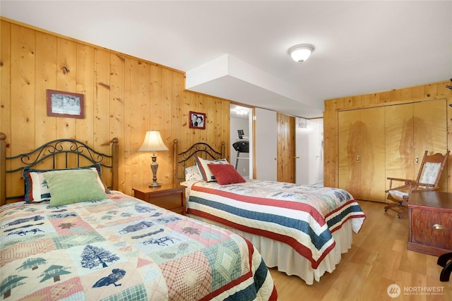 4004 Saje Ln, Sedro Woolley, WA 98284 - bedroom featuring light wood-style flooring, wooden walls, and a closet