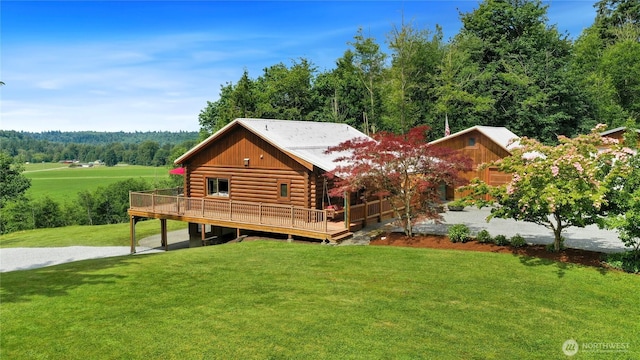 4004 Saje Ln, Sedro Woolley, WA 98284 - back of property featuring log exterior, a wooden deck, and a lawn