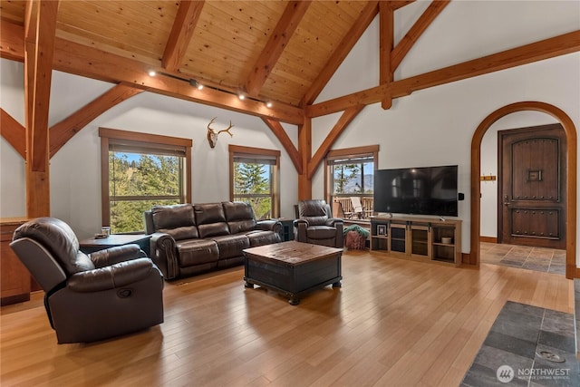 65 Fiddlers Rd, Winthrop, WA 98862 - living area featuring beam ceiling, arched walkways, plenty of natural light, light wood-style floors, and high vaulted ceiling