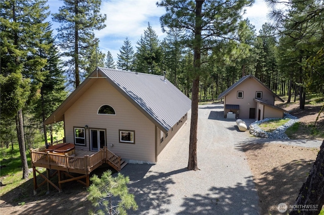 65 Fiddlers Rd, Winthrop, WA 98862 - rear view of house featuring a wooden deck, driveway, and a metal roof