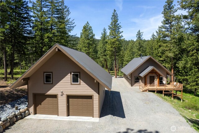 65 Fiddlers Rd, Winthrop, WA 98862 - view of front of home featuring a view of trees, an attached garage, and driveway