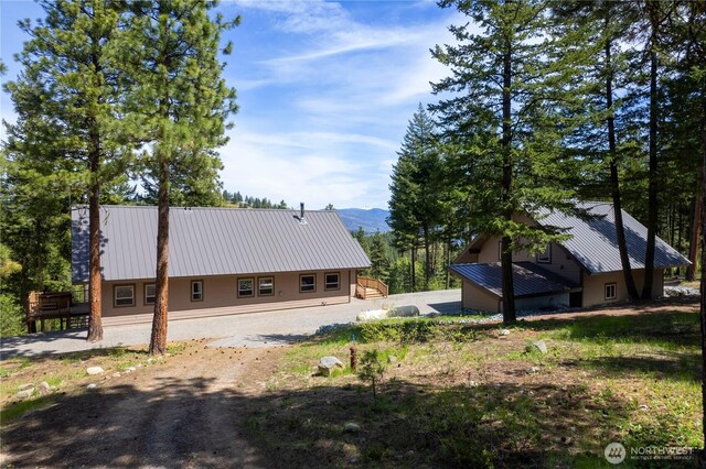 65 Fiddlers Rd, Winthrop, WA 98862 - rear view of house featuring a metal roof, a mountain view, and a chimney