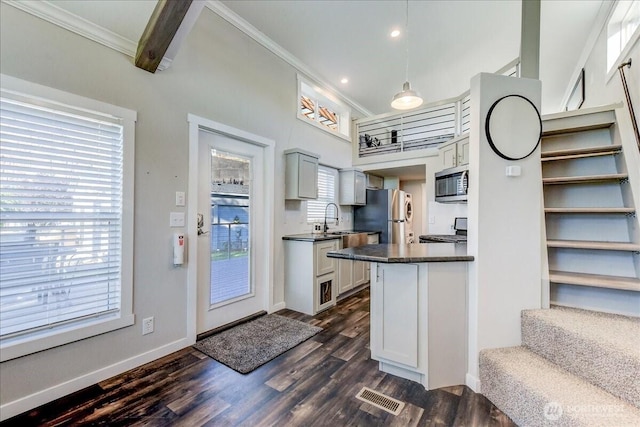 8542 Crescent Bar Rd NW Unit 346, Quincy, WA 98848 - kitchen with stainless steel appliances, dark countertops, ornamental molding, dark wood-style flooring, and recessed lighting
