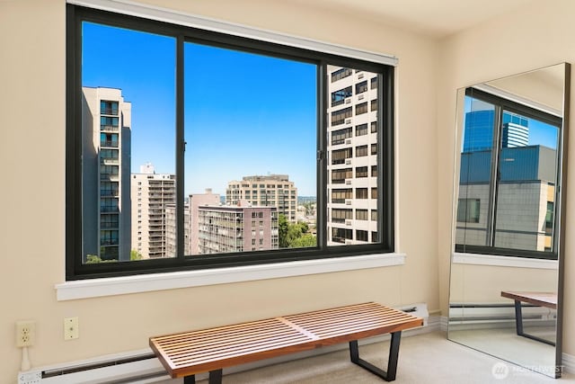 1105 Spring St Unit 1106, Seattle, WA 98104 - living area featuring carpet floors, a baseboard radiator, and a view of city