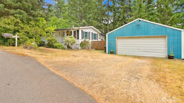 20 NE Wanda Ct, Belfair, WA 98528 - view of front facade with a garage, an outdoor structure, and a porch