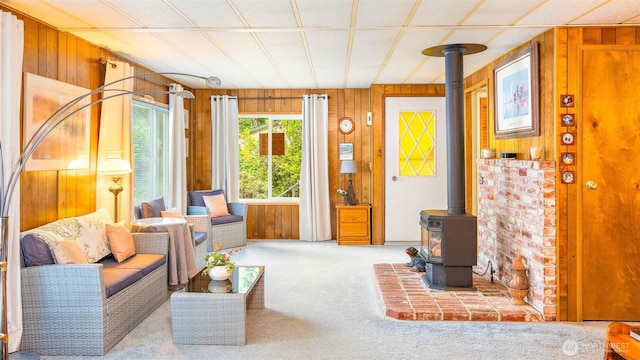 20 NE Wanda Ct, Belfair, WA 98528 - carpeted living area with wooden walls and a wood stove