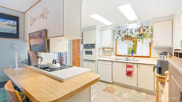 20 NE Wanda Ct, Belfair, WA 98528 - kitchen with white appliances, light countertops, a peninsula, and white cabinets