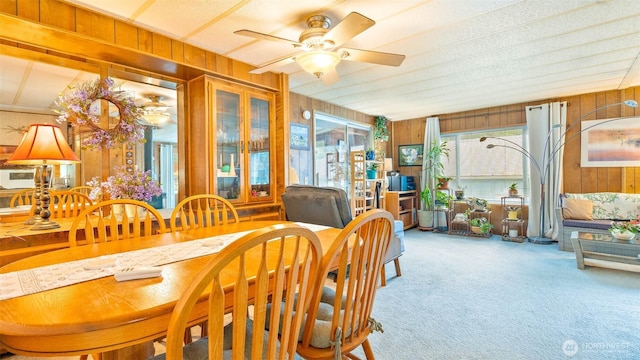 20 NE Wanda Ct, Belfair, WA 98528 - dining area featuring wood walls, carpet flooring, and a ceiling fan