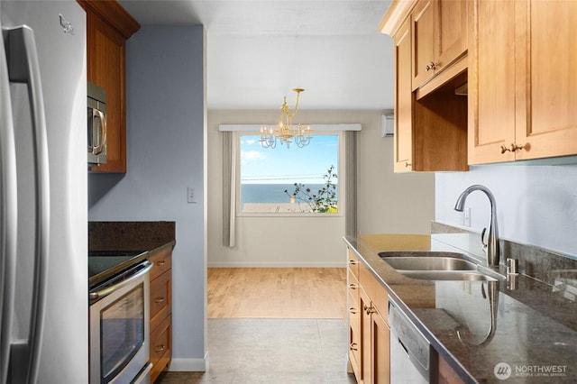 2834 Leeward Way, Bellingham, WA 98226 - kitchen with stainless steel appliances, a chandelier, dark stone counters, and hanging light fixtures