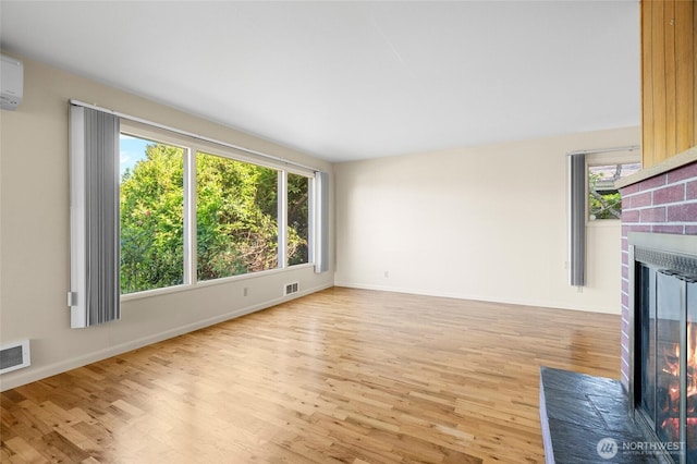 2834 Leeward Way, Bellingham, WA 98226 - unfurnished living room featuring a brick fireplace, plenty of natural light, and wood finished floors