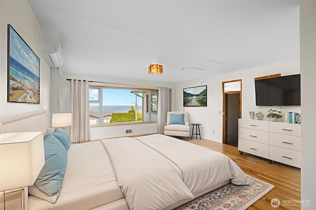 2834 Leeward Way, Bellingham, WA 98226 - bedroom with light wood finished floors, a wall mounted air conditioner, and attic access