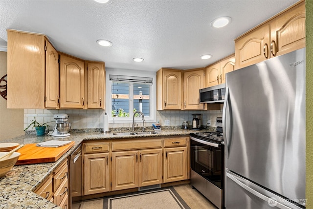 22023 11th Ave S, Des Moines, WA 98198 - kitchen with appliances with stainless steel finishes, tasteful backsplash, a textured ceiling, recessed lighting, and light stone countertops