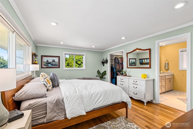 22023 11th Ave S, Des Moines, WA 98198 - bedroom featuring ornamental molding, recessed lighting, light wood-type flooring, ensuite bathroom, and a spacious closet