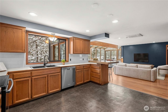 11358 River Bend Dr, Leavenworth, WA 98826 - kitchen with stainless steel appliances, a peninsula, open floor plan, light countertops, and backsplash