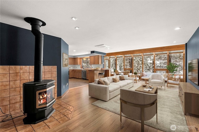 11358 River Bend Dr, Leavenworth, WA 98826 - living room with a wood stove, light wood-type flooring, and recessed lighting
