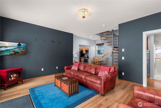 11358 River Bend Dr, Leavenworth, WA 98826 - living room featuring stairs, wood finished floors, and a wood stove