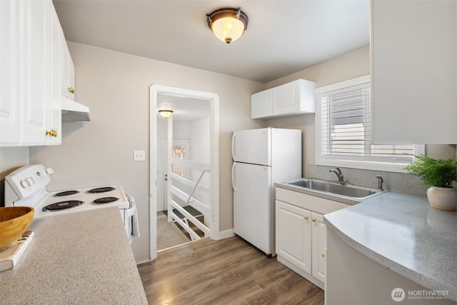 6017 Fauntleroy Way SW, Seattle, WA 98136 - kitchen with white appliances, exhaust hood, light wood-type flooring, white cabinets, and light countertops