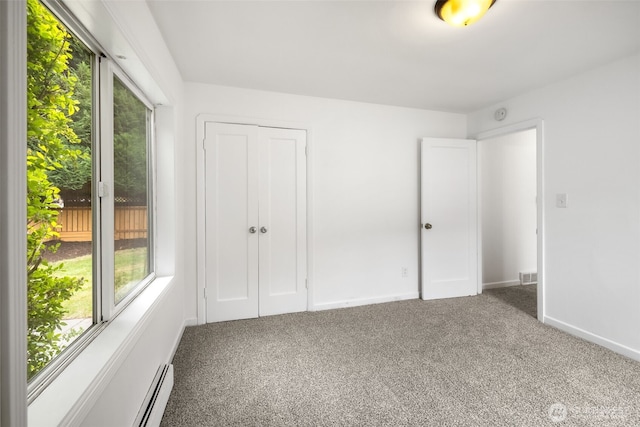 6017 Fauntleroy Way SW, Seattle, WA 98136 - unfurnished bedroom with carpet, a closet, and a baseboard radiator