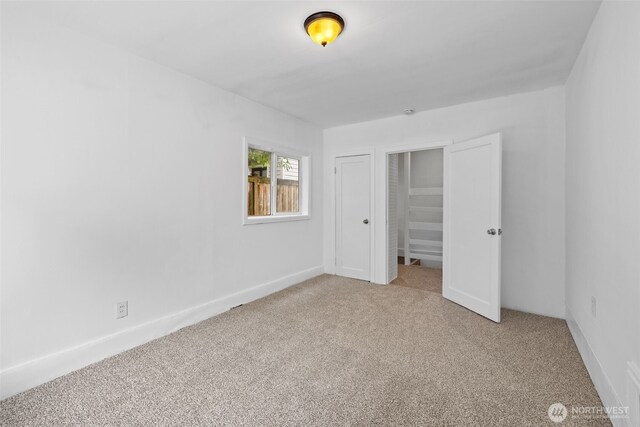 6017 Fauntleroy Way SW, Seattle, WA 98136 - unfurnished bedroom with carpet floors and baseboards
