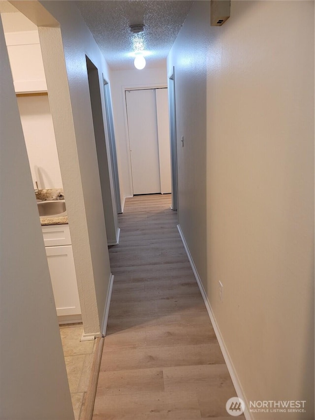 102 Garden Hill Rd, Elma, WA 98541 - corridor featuring a textured ceiling and light wood-type flooring