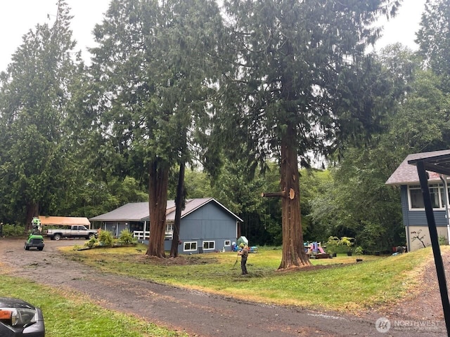 102 Garden Hill Rd, Elma, WA 98541 - view of front facade with a front lawn and view of wooded area