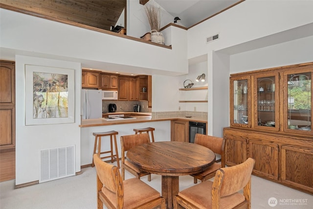 225 NE 19th St Unit 24, East Wenatchee, WA 98802 - dining room featuring light carpet, a towering ceiling, and wine cooler