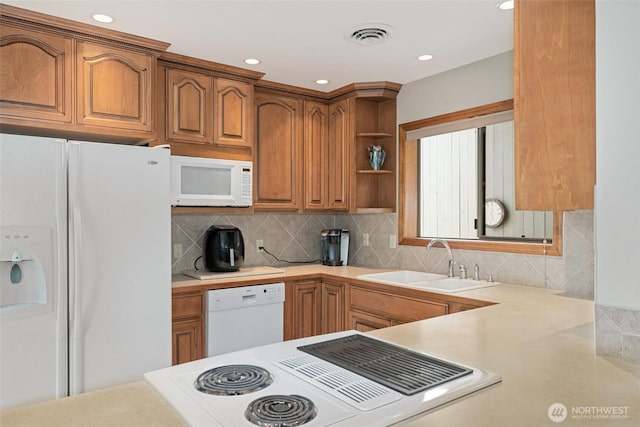 225 NE 19th St Unit 24, East Wenatchee, WA 98802 - kitchen with white appliances, light countertops, backsplash, brown cabinets, and recessed lighting