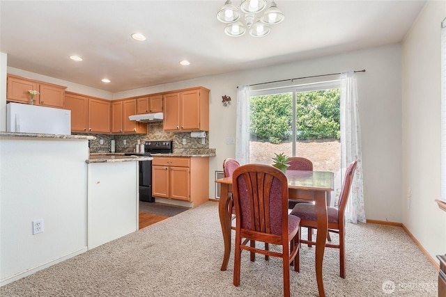 1339 Spruce St, Lynden, WA 98264 - kitchen with electric range, carpet floors, a chandelier, under cabinet range hood, and recessed lighting