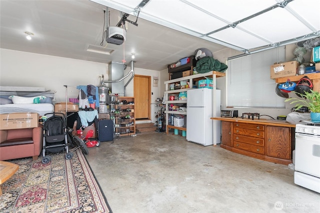 1339 Spruce St, Lynden, WA 98264 - garage featuring freestanding refrigerator, a garage door opener, and water heater
