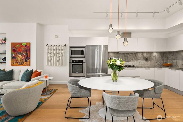 1920 4th Ave Unit 604, Seattle, WA 98101 - dining room featuring light wood-style floors and track lighting