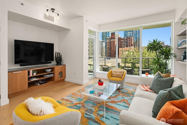 1920 4th Ave Unit 604, Seattle, WA 98101 - living room featuring light wood-style floors and a city view