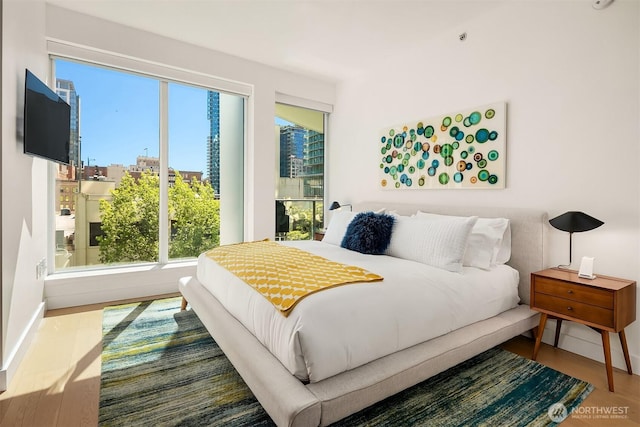 1920 4th Ave Unit 604, Seattle, WA 98101 - bedroom featuring wood finished floors and a view of city
