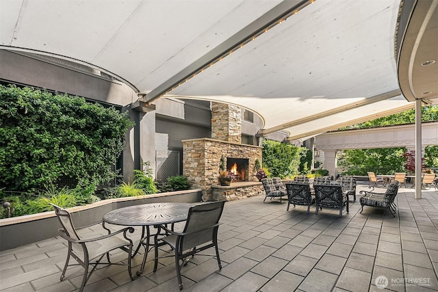 1920 4th Ave Unit 604, Seattle, WA 98101 - view of patio with outdoor dining space and an outdoor living space with a fireplace