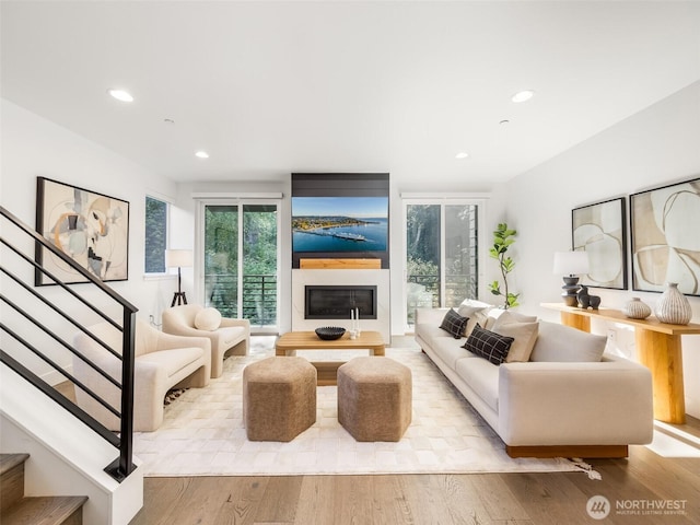 18517 96th Dr NE Unit A, Bothell, WA 98011 - living area featuring stairs, recessed lighting, a glass covered fireplace, and light wood-type flooring