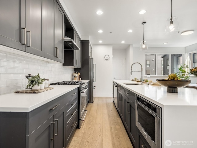 18517 96th Dr NE Unit A, Bothell, WA 98011 - kitchen with appliances with stainless steel finishes, light wood finished floors, tasteful backsplash, light countertops, and recessed lighting