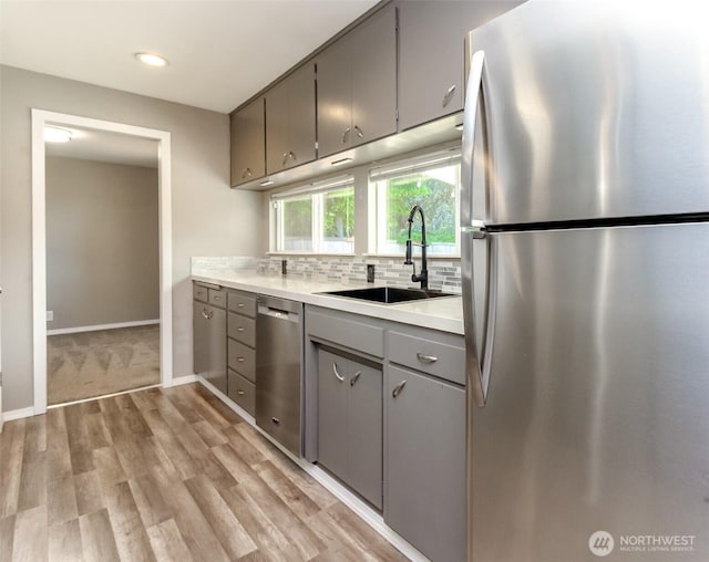 32206 27th Ave SW, Federal Way, WA 98032 - kitchen featuring stainless steel appliances, gray cabinets, light countertops, tasteful backsplash, and light wood-style flooring