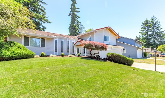 32206 27th Ave SW, Federal Way, WA 98032 - view of front of property with a front yard, concrete driveway, an attached garage, and a tiled roof