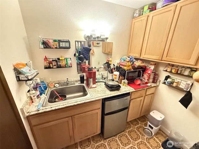 408 Main St, Conconully, WA 98844 - kitchen with light brown cabinetry, light countertops, dishwasher, and light tile patterned floors