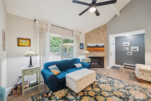 12912 62nd Ave NW Unit B5, Gig Harbor, WA 98332 - living room featuring high vaulted ceiling, wood finished floors, a ceiling fan, beam ceiling, and a fireplace
