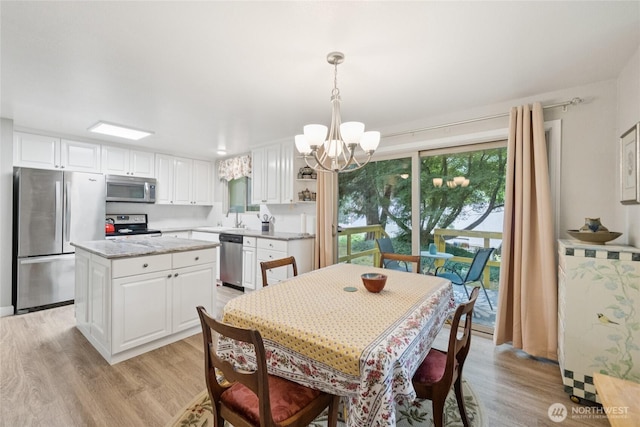 12912 62nd Ave NW Unit B5, Gig Harbor, WA 98332 - dining room featuring a chandelier and light wood-style floors